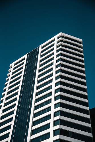 building low angle photo of white curtain wall building town
